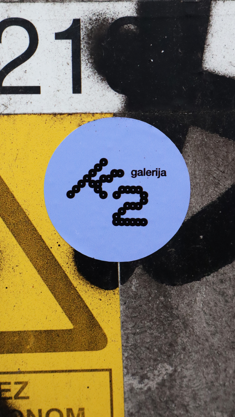 Gallery K2 visual identity displayed on a circular street sign